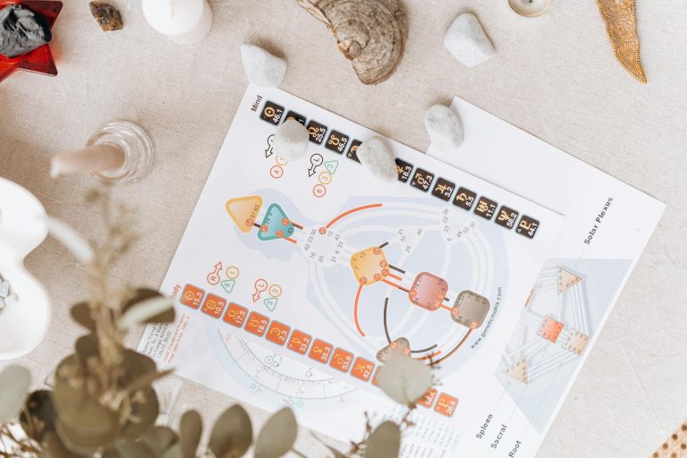 A serene setup of spiritual diagrams and crystals on a beige surface, symbolizing holistic healing and balance.
